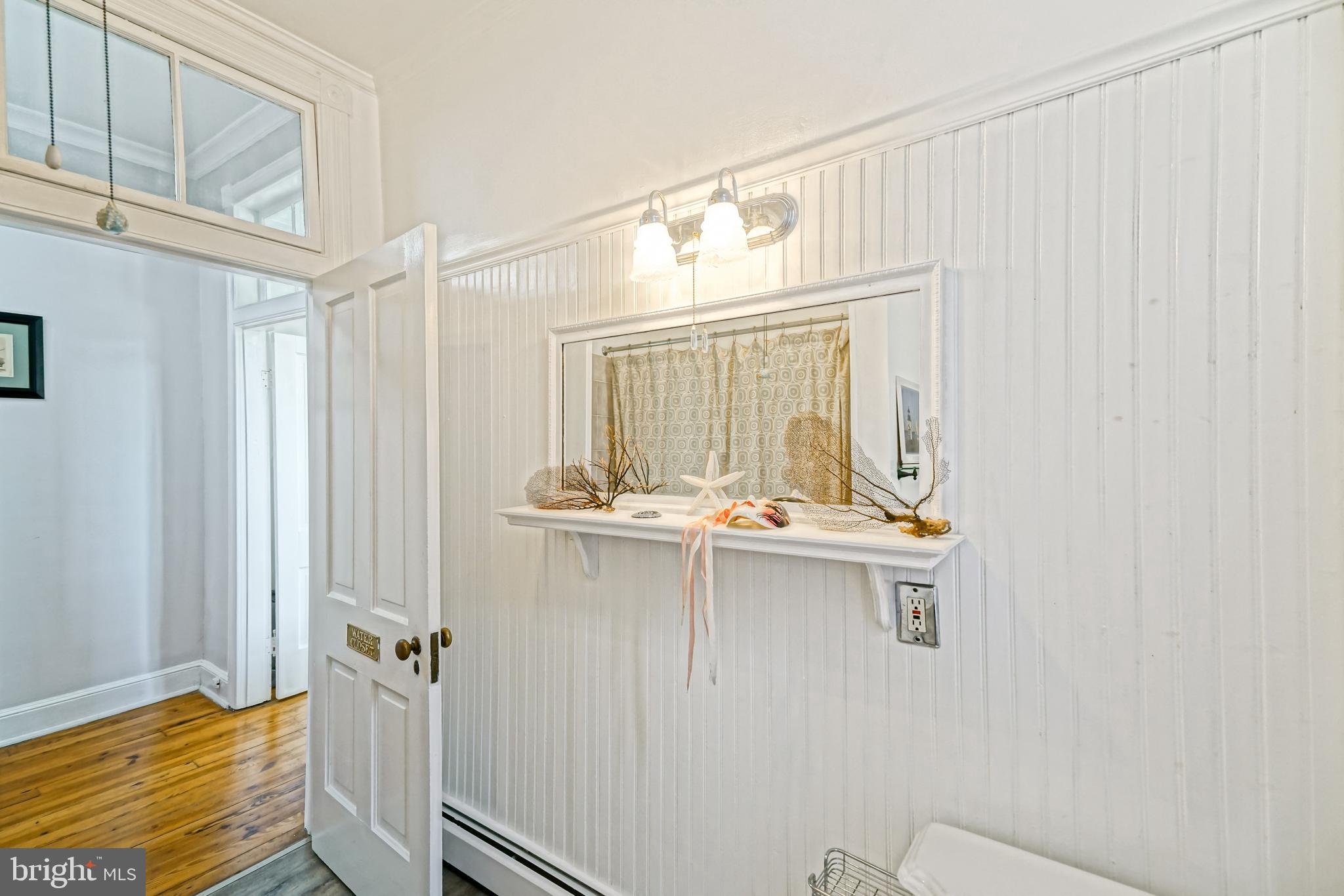 407 Savannah Road Lewes, DE 19958 - Photo 32 of 44 a bathroom with a sink and mirror with bathtub