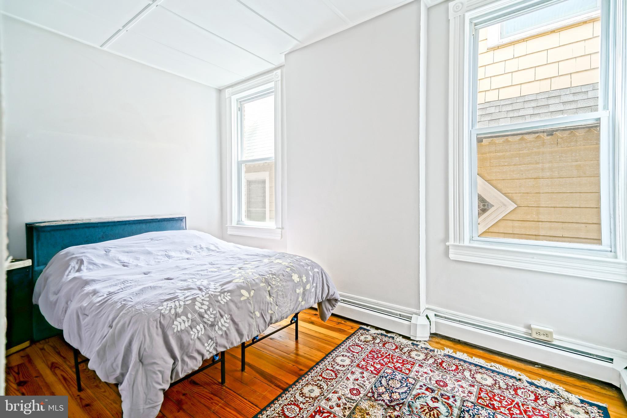 407 Savannah Road Lewes, DE 19958 - Photo 33 of 44 a bed sitting in a bedroom next to a window