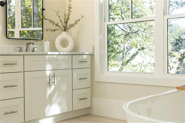 a bathroom with a bathtub and a window