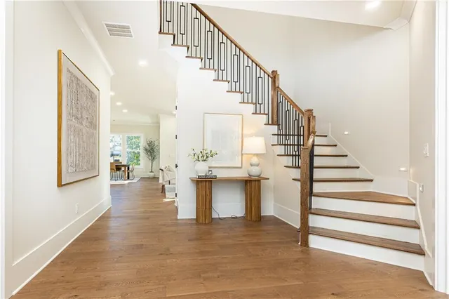 a view of entryway and hall with wooden floor