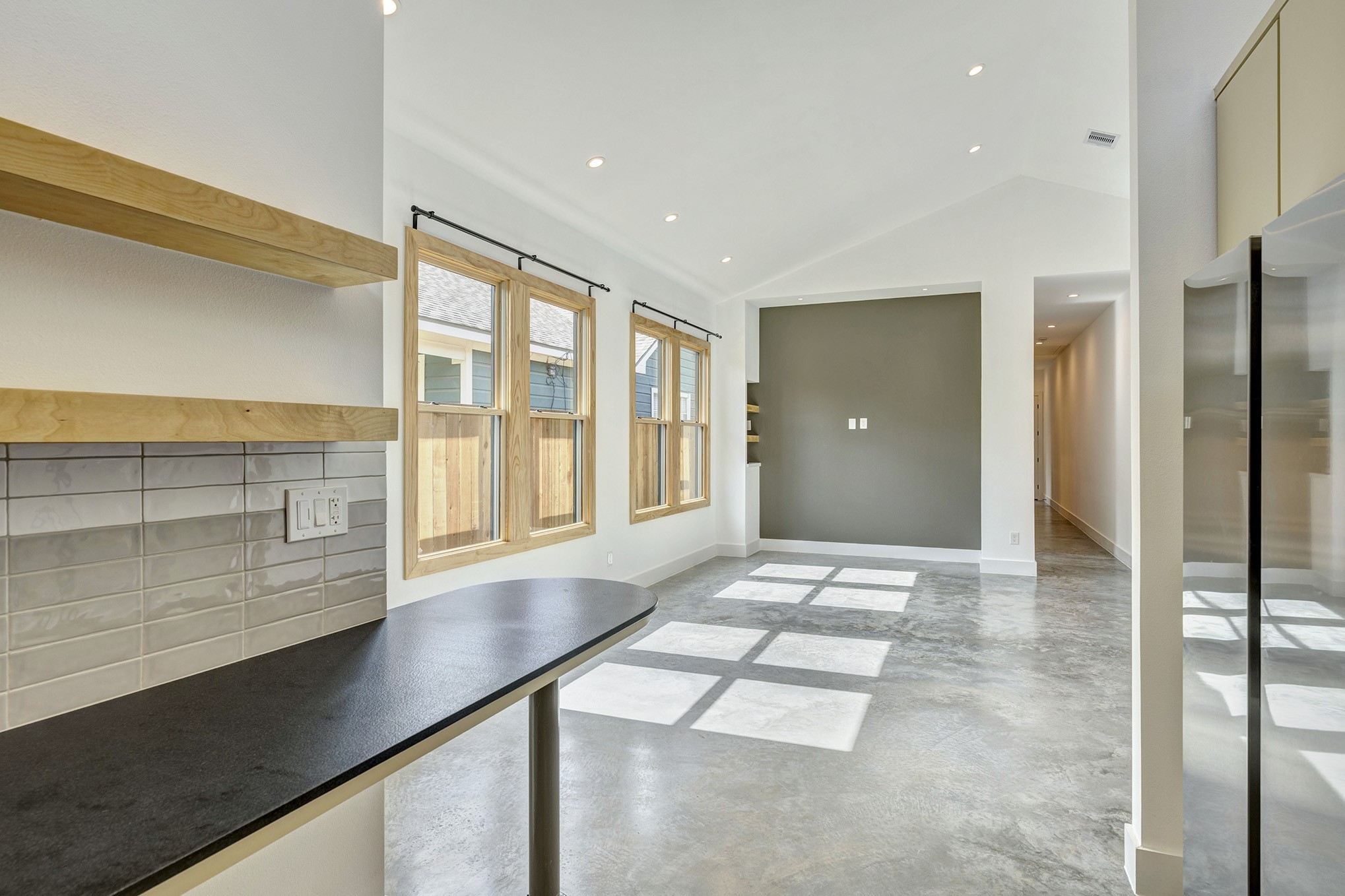 907 Kern Street, Unit A Houston, TX 77009 - Photo 5 of 18 View looking out from kitchen to dining/living area. Breakfast bar is in place for casual quick meals.