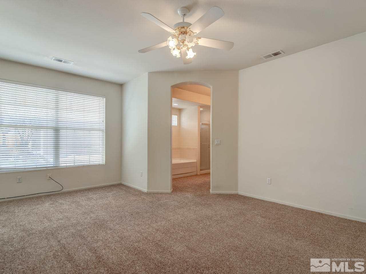 9647 Truckee Meadows Place Reno, NV 89521 - Photo 12 of 25 an empty room with a window and a ceiling fan