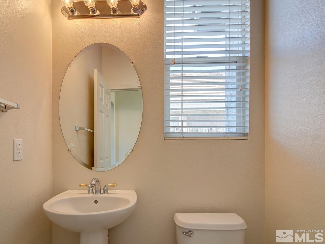 9647 Truckee Meadows Place Reno, NV 89521 - Photo 20 of 25 a bathroom with a toilet sink and mirror