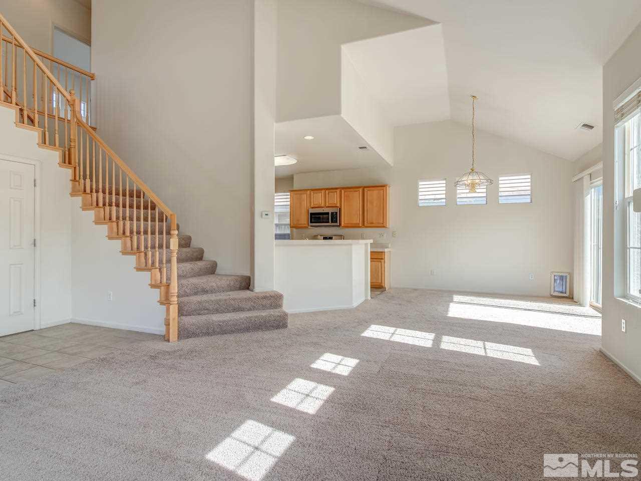 9647 Truckee Meadows Place Reno, NV 89521 - Photo 7 of 25 a view of a hallway with entryway wooden floor and a kitchen