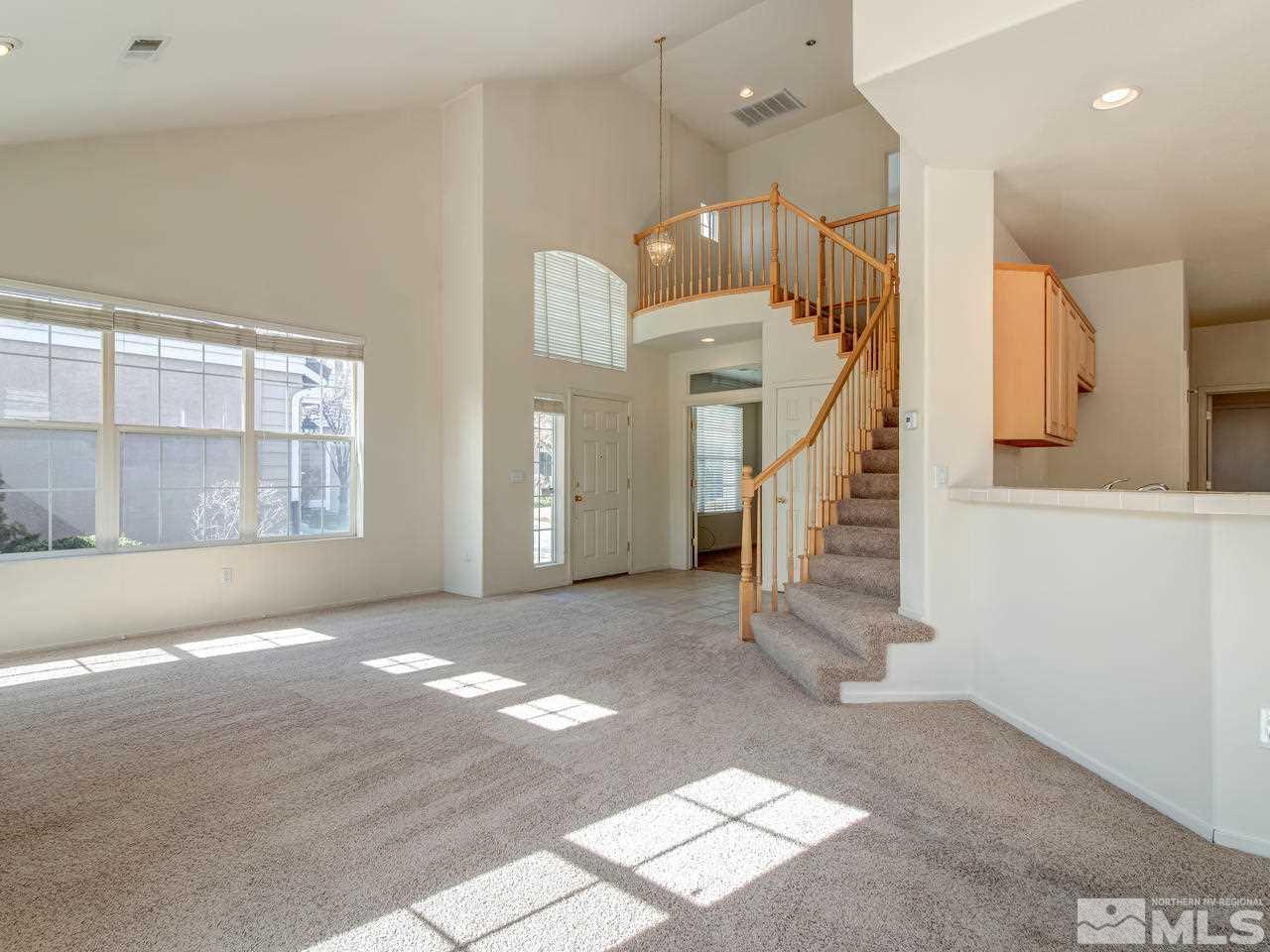 9647 Truckee Meadows Place Reno, NV 89521 - Photo 8 of 25 a view of an empty room with a fireplace and windows