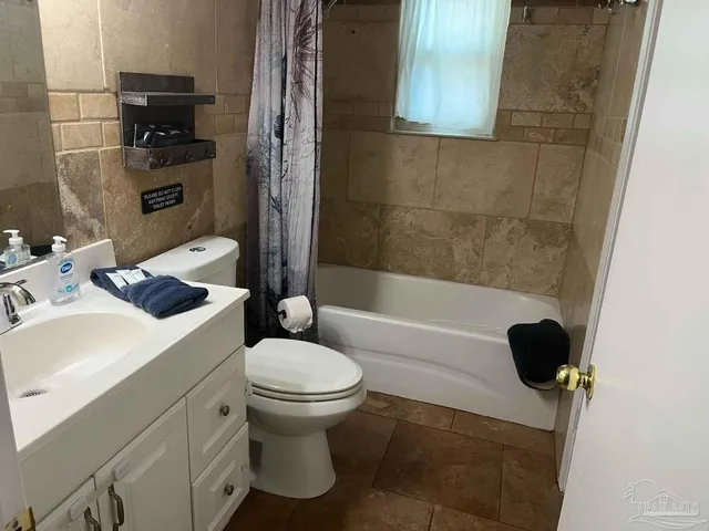a bathroom with a shower a toilet and a bathtub