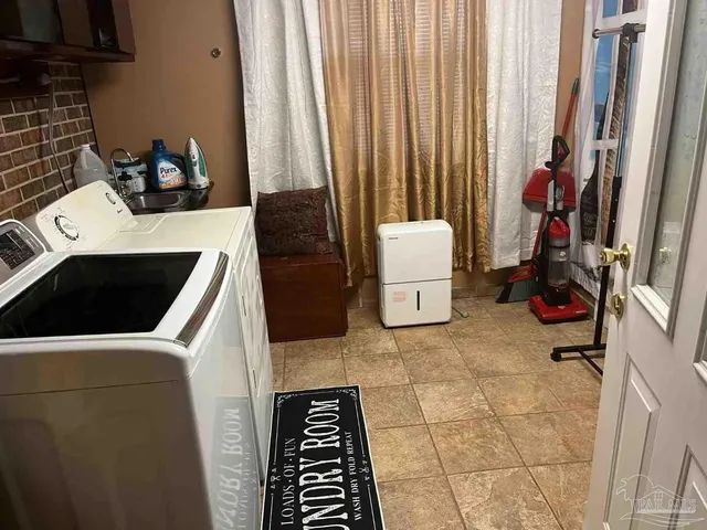 a bedroom with a bed and a flat tv screen on a dresser