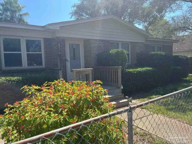 a front view of a house with a yard and a garage