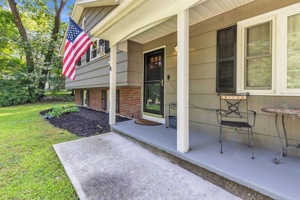 a view of a house with backyard and porch