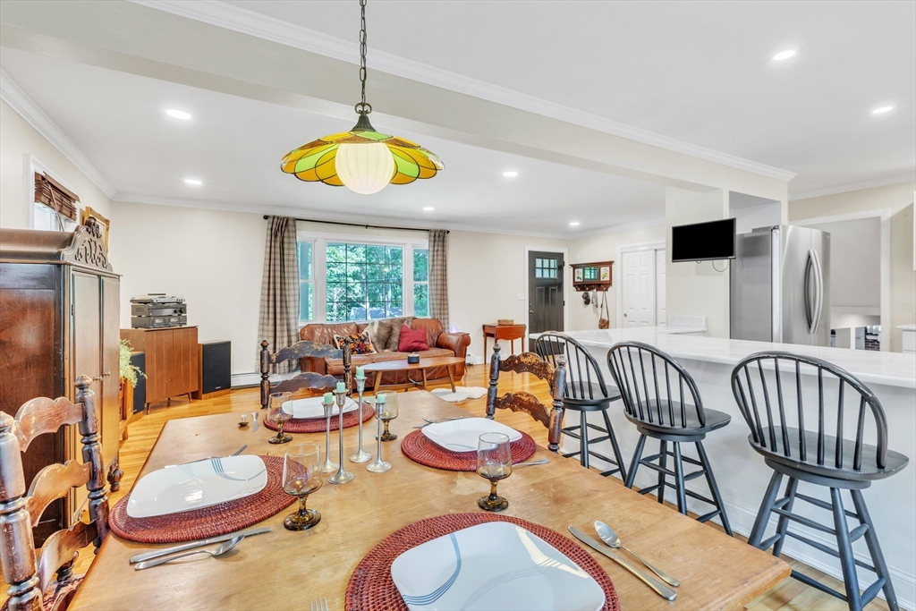 4 Colonial Road Sutton, MA 01590 - Photo 12 of 38 a living room with furniture a chandelier and a dining table