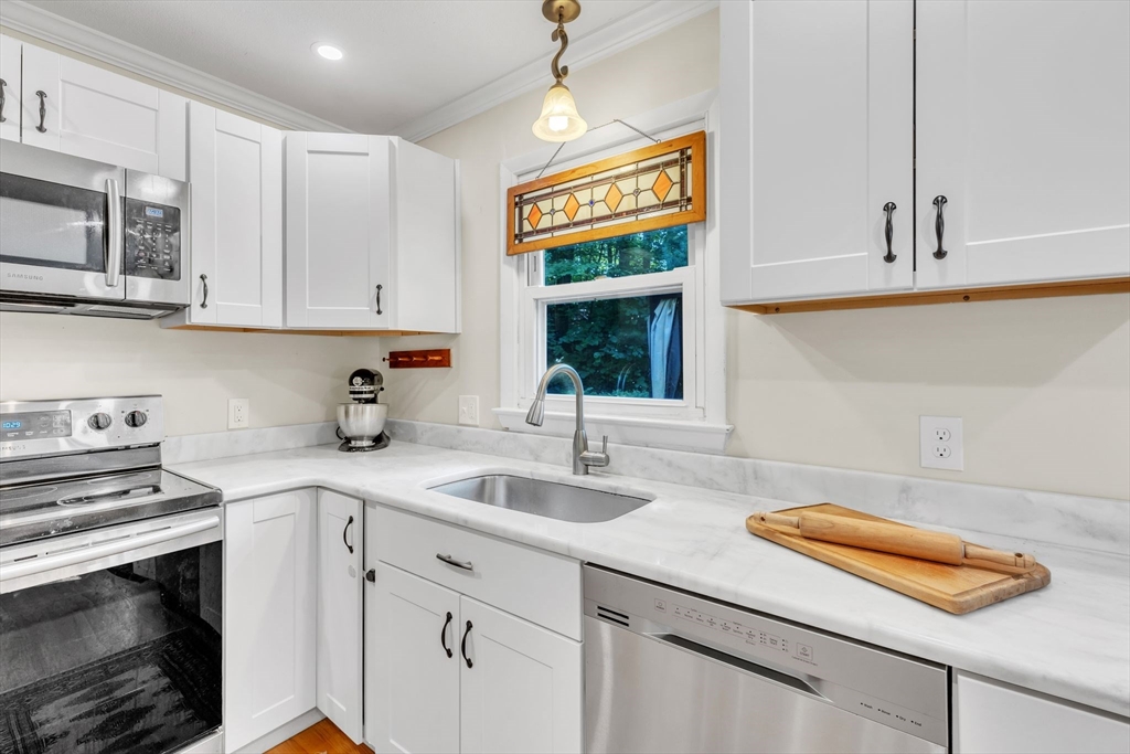 4 Colonial Road Sutton, MA 01590 - Photo 15 of 38 a kitchen with stainless steel appliances granite countertop a sink a stove and cabinets