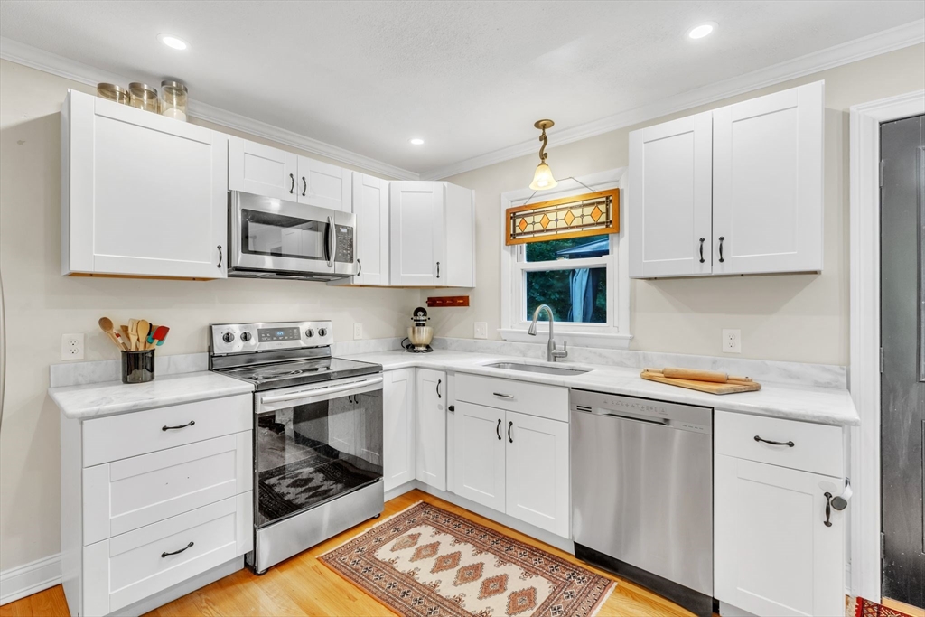 4 Colonial Road Sutton, MA 01590 - Photo 16 of 38 a kitchen with granite countertop a sink cabinets and stainless steel appliances