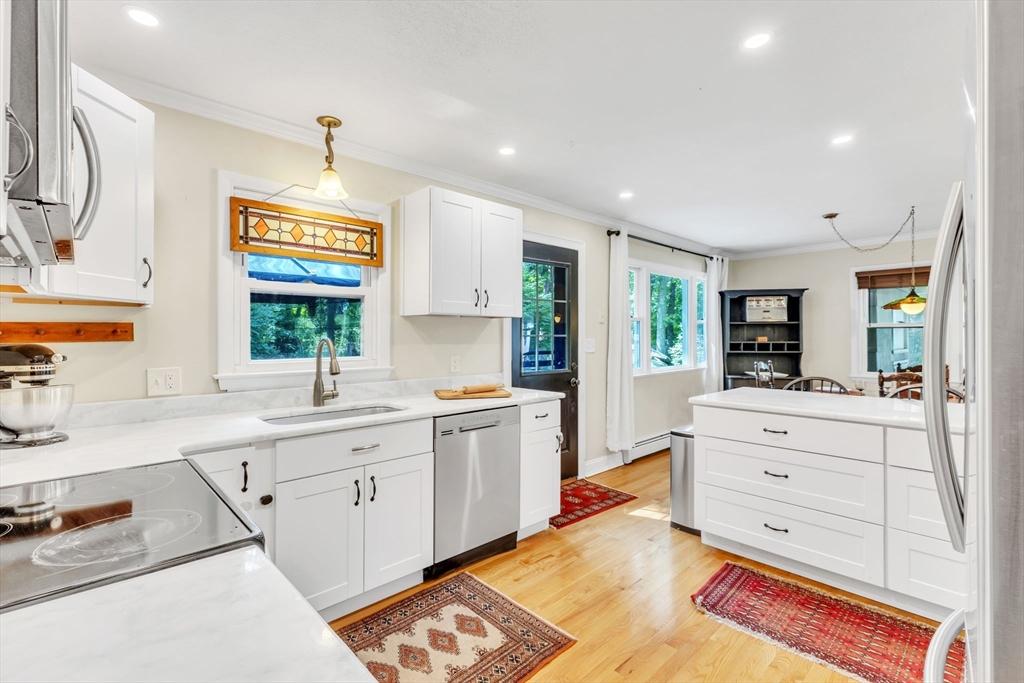 4 Colonial Road Sutton, MA 01590 - Photo 18 of 38 a large kitchen with a stove a sink and a refrigerator