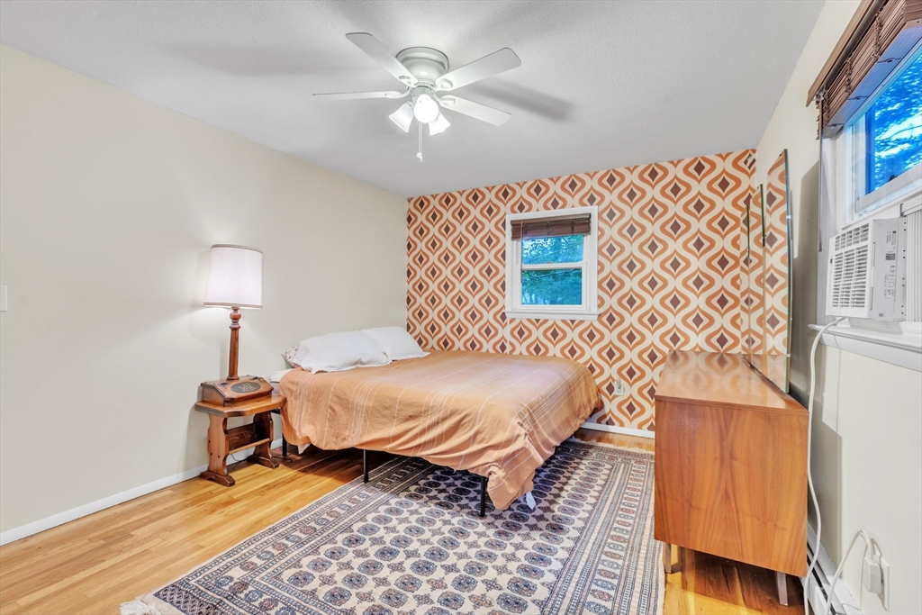 4 Colonial Road Sutton, MA 01590 - Photo 19 of 38 a bedroom with a bed and a lamp on dresser