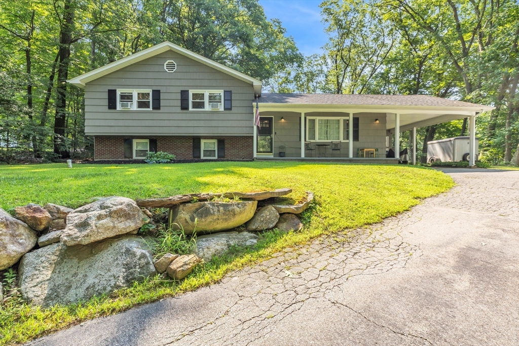 4 Colonial Road Sutton, MA 01590 - Photo 2 of 38 a front view of a house with a yard and porch