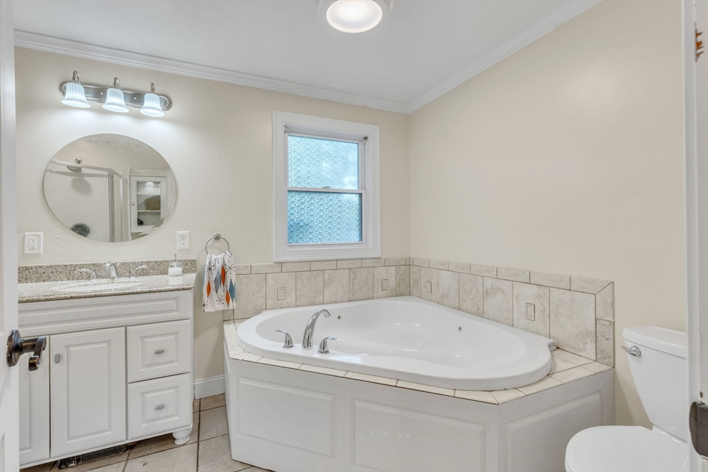 4 Colonial Road Sutton, MA 01590 - Photo 24 of 38 a bathroom with a granite countertop sink a toilet and bathtub
