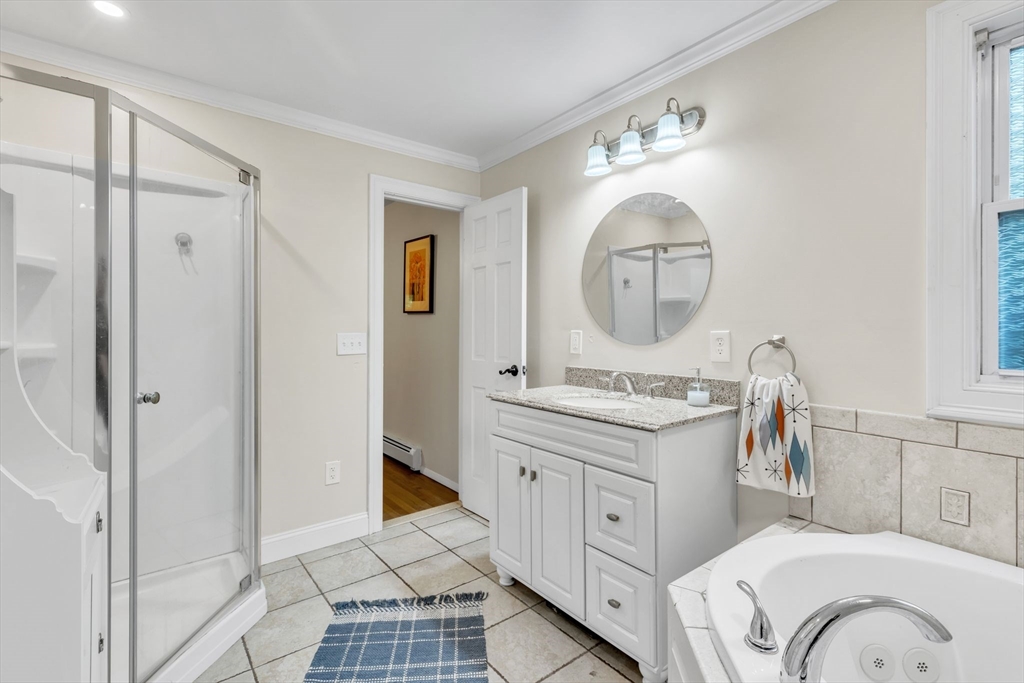 4 Colonial Road Sutton, MA 01590 - Photo 25 of 38 a spacious bathroom with a mirror sink and a mirror