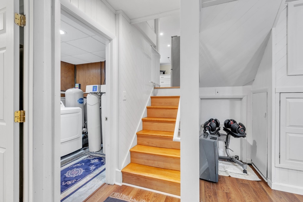 4 Colonial Road Sutton, MA 01590 - Photo 27 of 38 a view of a hallway with wooden floor and staircase