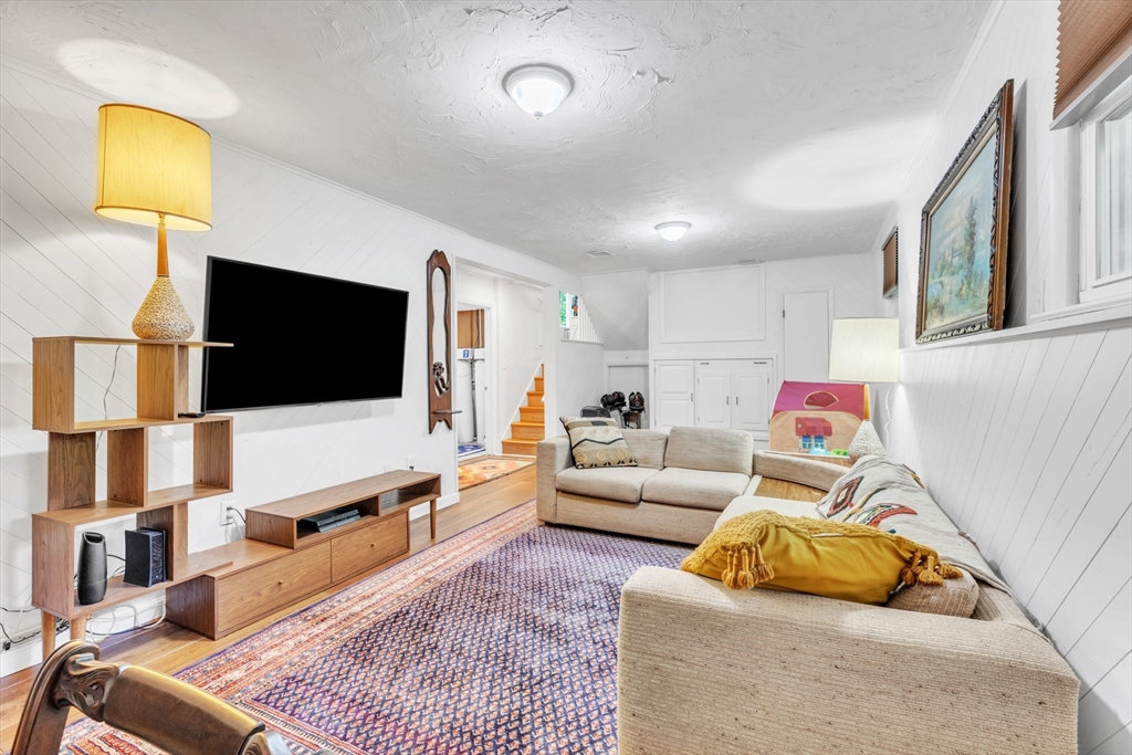 4 Colonial Road Sutton, MA 01590 - Photo 30 of 38 a living room with furniture and a flat screen tv