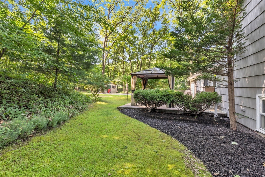 4 Colonial Road Sutton, MA 01590 - Photo 38 of 38 a view of a house with a yard and sitting area