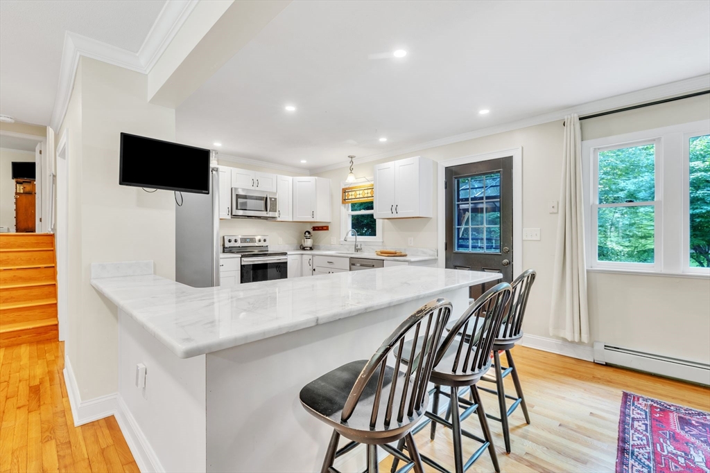4 Colonial Road Sutton, MA 01590 - Photo 9 of 38 a large kitchen with a table and chairs