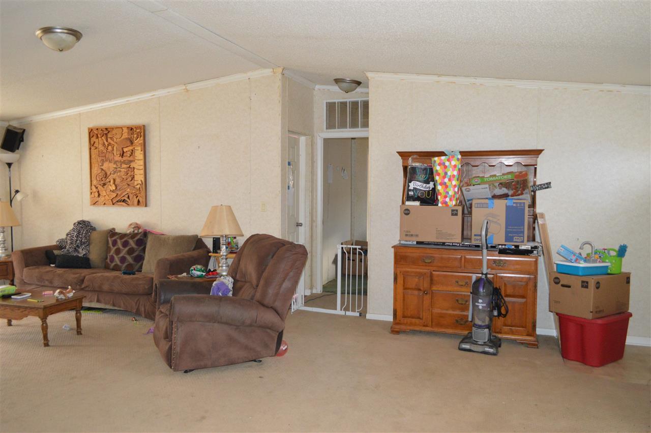 564 39 Road Palisade, CO 81526 - Photo 4 of 22 a living room with furniture and a dresser