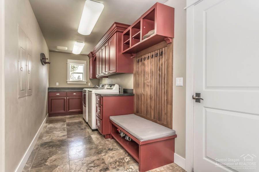 63528 Old Deschutes Road Bend, OR 97701 - Photo 14 of 25 a kitchen with stainless steel appliances granite countertop a refrigerator a sink dishwasher and wooden cabinets