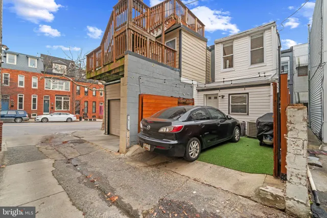 a car parked in front of a brick house