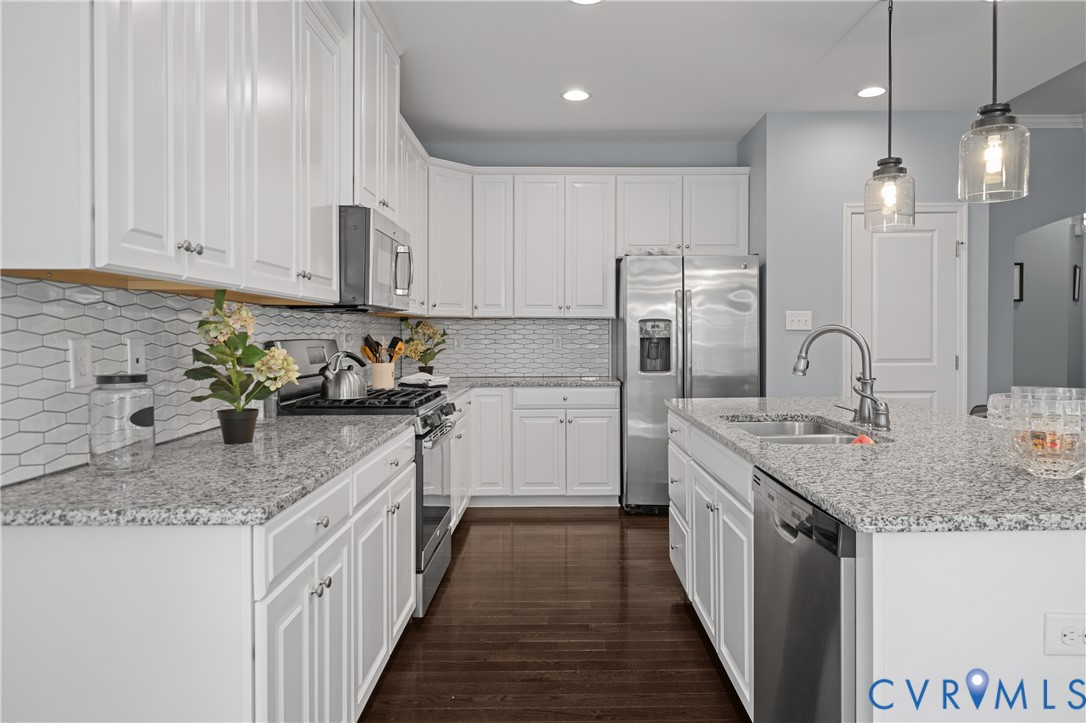 1012 Water Beech Road Midlothian, VA 23114 - Photo 12 of 47 a kitchen with stainless steel appliances granite countertop a sink stove and cabinets