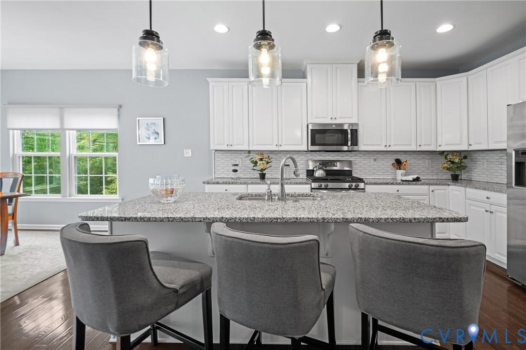 1012 Water Beech Road Midlothian, VA 23114 - Photo 14 of 47 a kitchen with stainless steel appliances granite countertop a sink a stove a microwave a refrigerator and cabinets