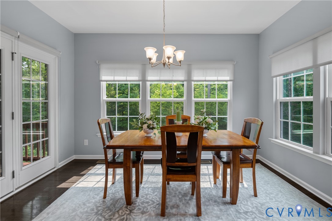1012 Water Beech Road Midlothian, VA 23114 - Photo 17 of 47 a view of a dining room with furniture a chandelier and wooden floor