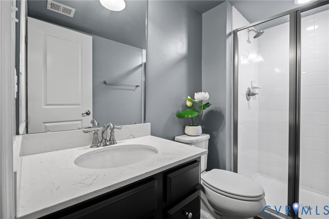 1012 Water Beech Road Midlothian, VA 23114 - Photo 29 of 47 a bathroom with a granite countertop sink toilet and a mirror