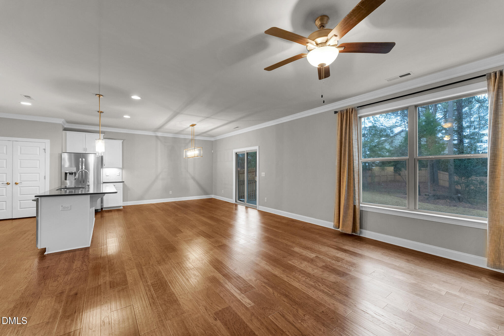 928 Barringer Drive Raleigh, NC 27606 - Photo 12 of 40 a view of an empty room with a window and kitchen view