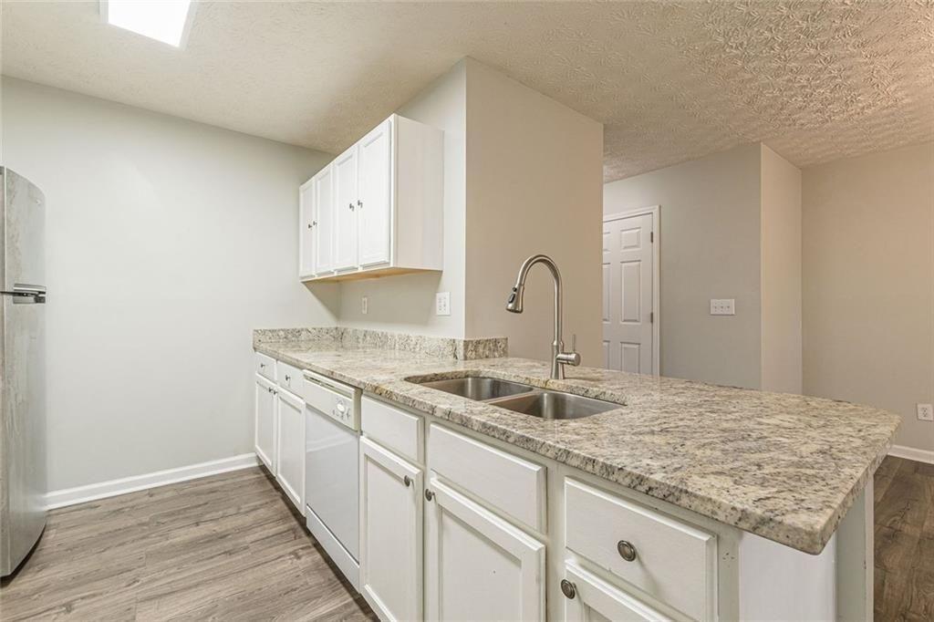 3151 Kingswood Glen Decatur, GA 30034 - Photo 12 of 38 a kitchen with granite countertop a sink and a stove
