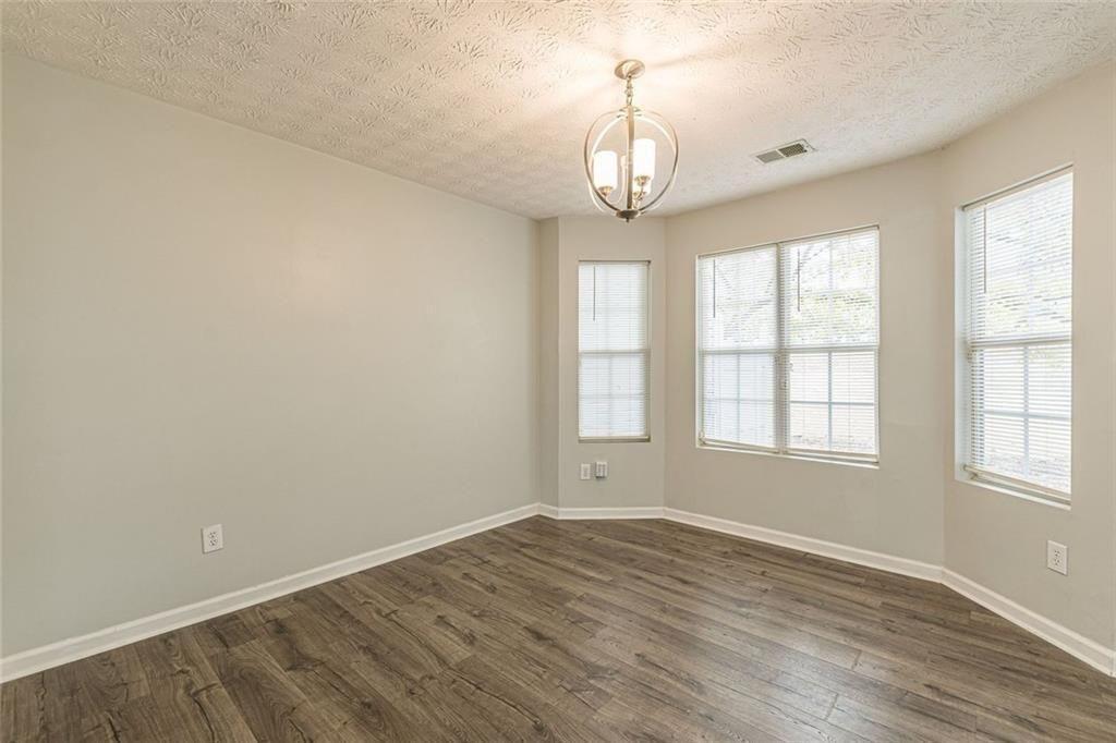 3151 Kingswood Glen Decatur, GA 30034 - Photo 16 of 38 an empty room with wooden floor and windows