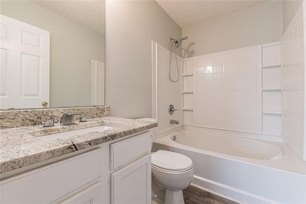 3151 Kingswood Glen Decatur, GA 30034 - Photo 26 of 38 a bathroom with a granite countertop sink a toilet and bathtub