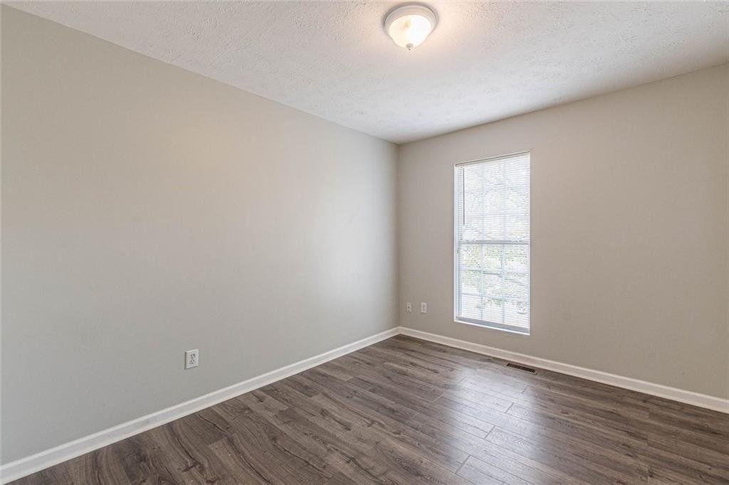 3151 Kingswood Glen Decatur, GA 30034 - Photo 33 of 38 an empty room with wooden floor and windows