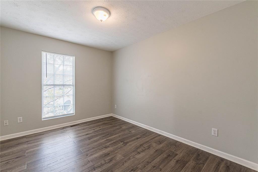 3151 Kingswood Glen Decatur, GA 30034 - Photo 35 of 38 an empty room with wooden floor and windows