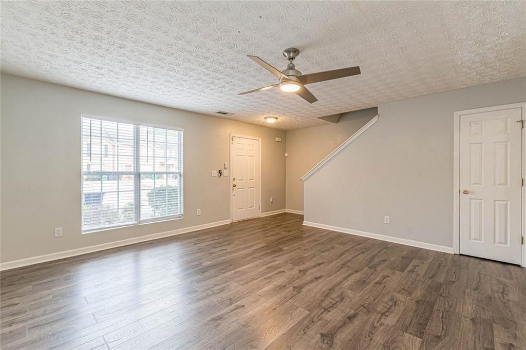 3151 Kingswood Glen Decatur, GA 30034 - Photo 5 of 38 an empty room with wooden floor fan and windows