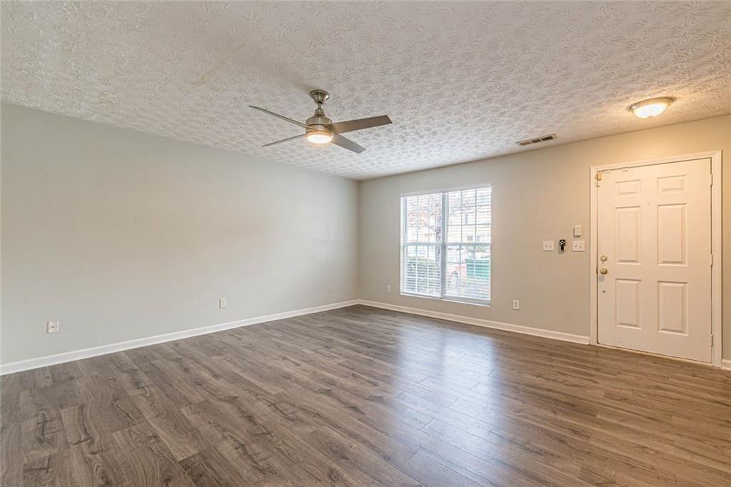 3151 Kingswood Glen Decatur, GA 30034 - Photo 7 of 38 a view of an empty room with a window and wooden floor