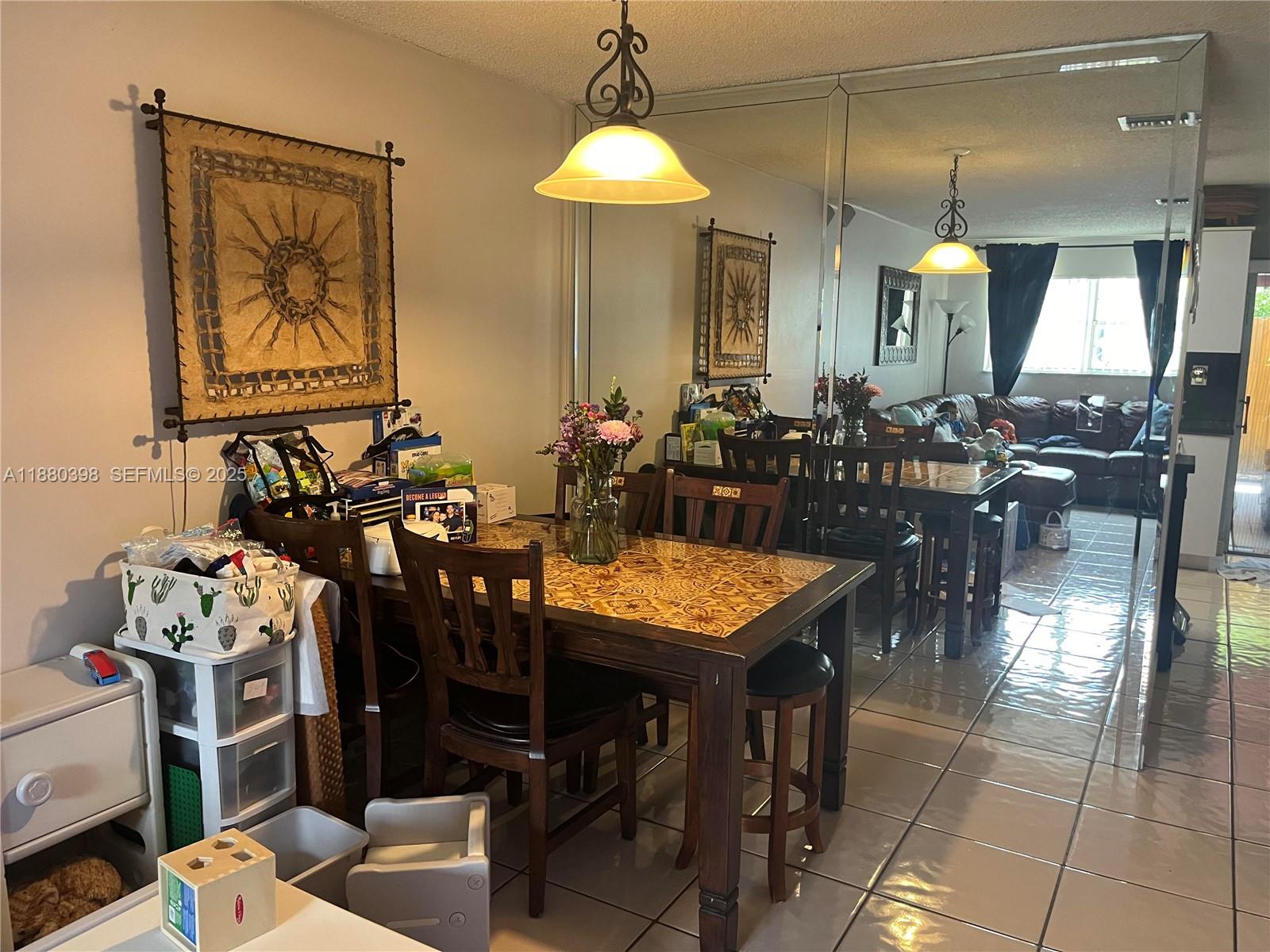 6275 Southwest 130th Avenue, Unit 805 Miami, FL 33183 - Photo 4 of 12 a dining room filled with lots of furniture and a chandelier