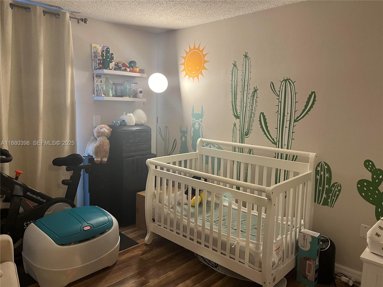 6275 Southwest 130th Avenue, Unit 805 Miami, FL 33183 - Photo 8 of 12 a bedroom with a bed and wooden floor