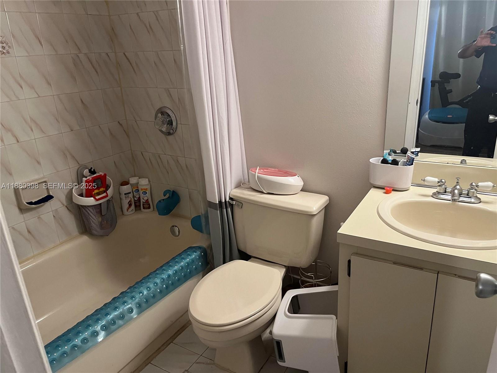 6275 Southwest 130th Avenue, Unit 805 Miami, FL 33183 - Photo 9 of 12 a white toilet sitting next to a bathroom sink