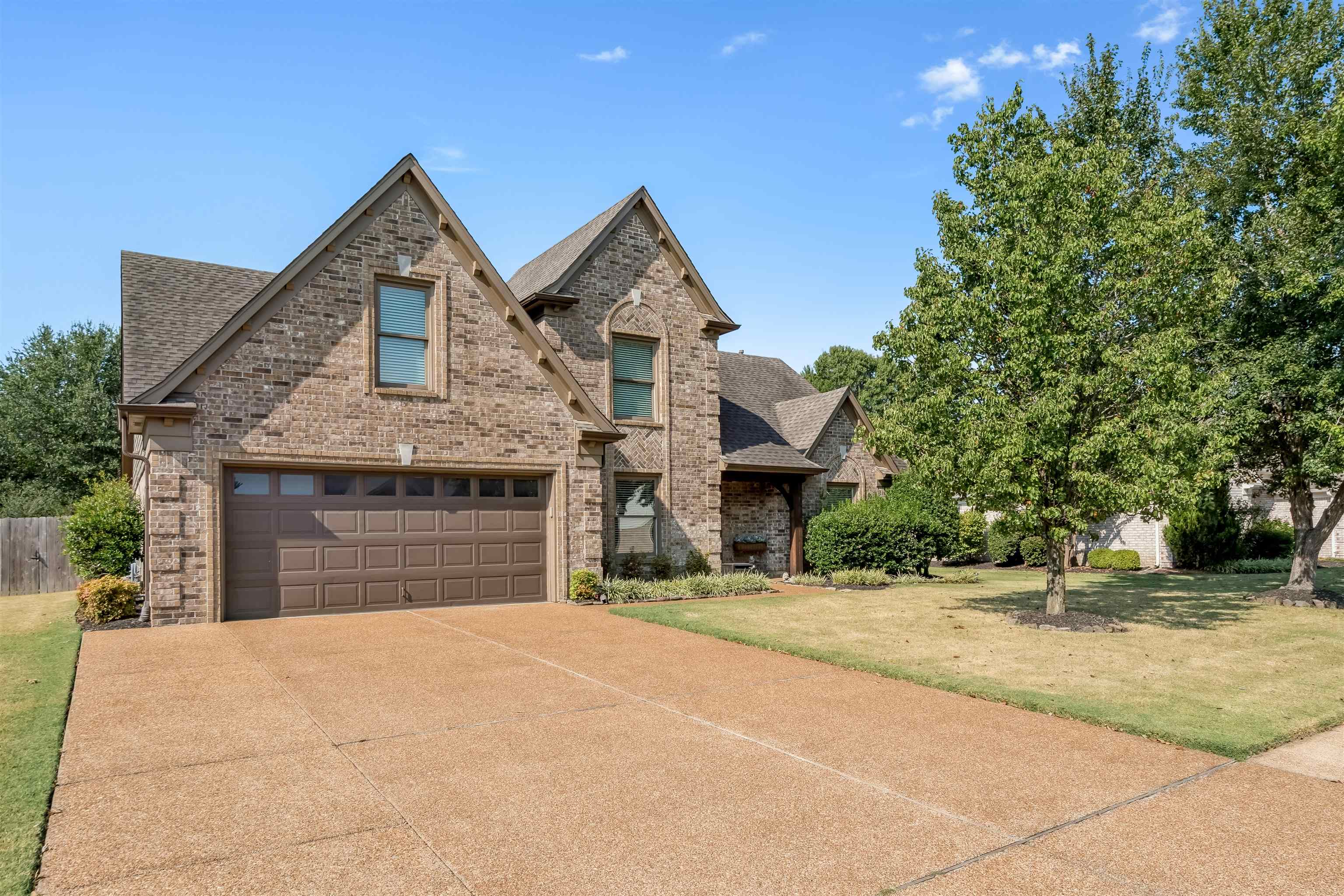 1337 Hunters Mill Trail Collierville, TN 38017 - Photo 1 of 25 a front view of a house with a yard and garage