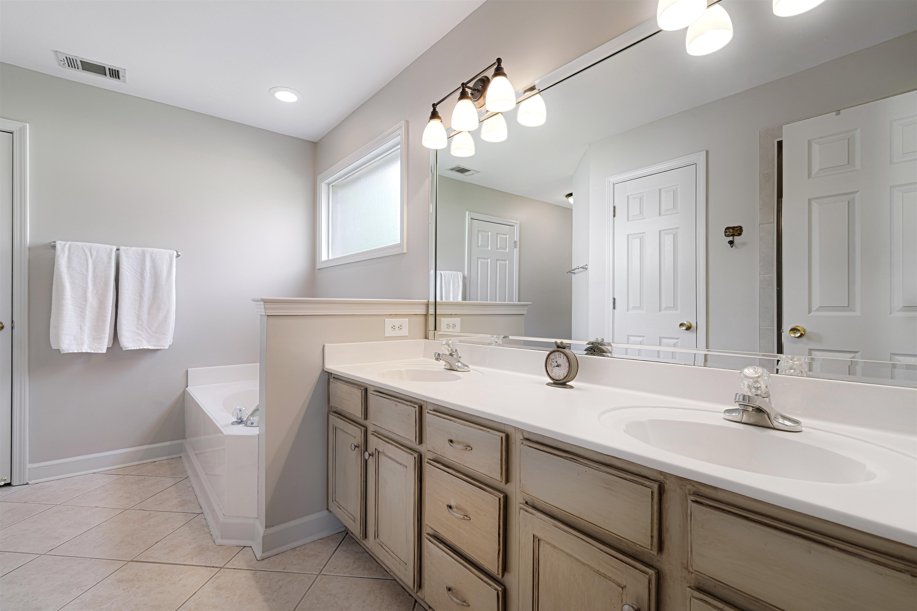 1337 Hunters Mill Trail Collierville, TN 38017 - Photo 14 of 25 a bathroom with a double vanity sink and a mirror