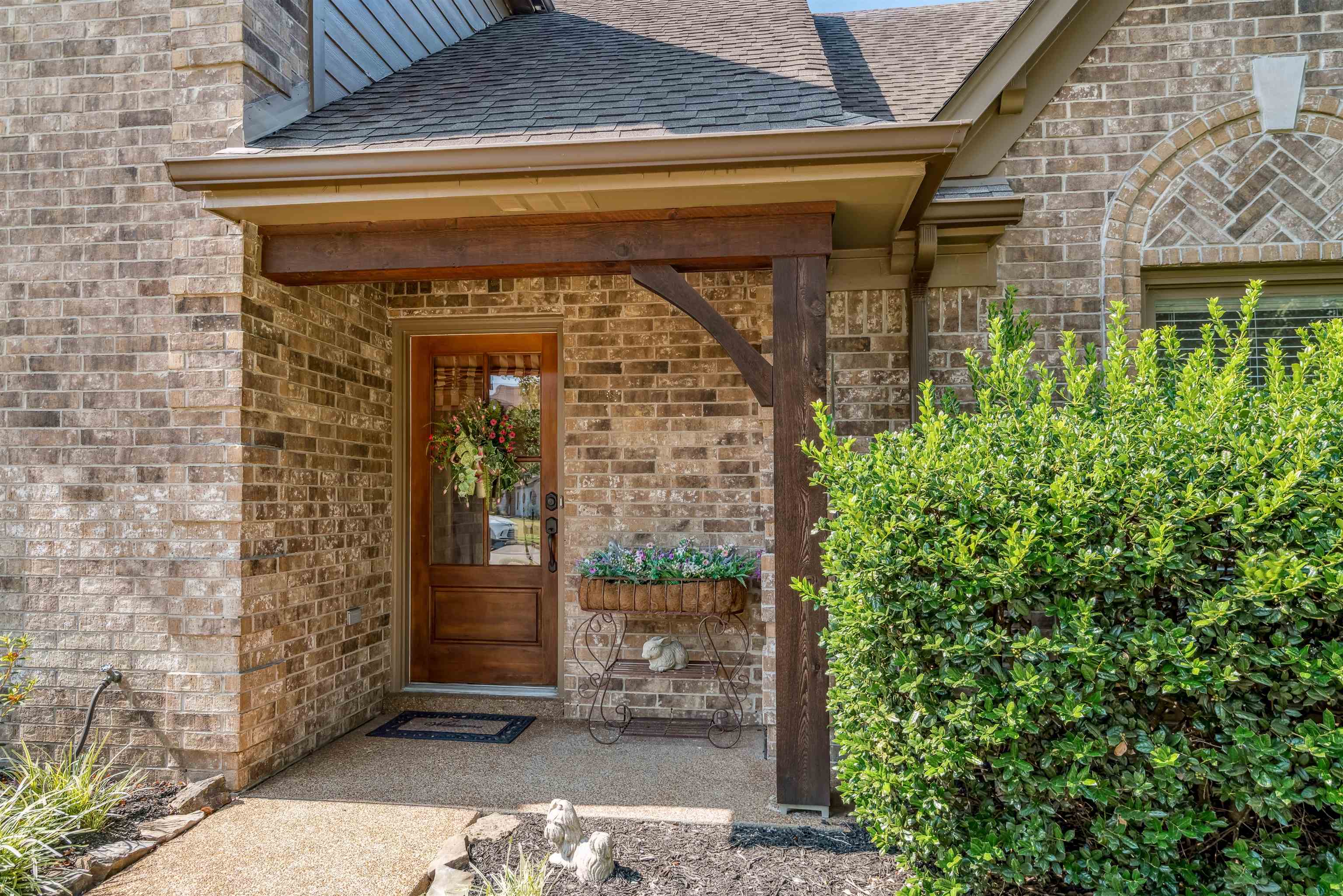 1337 Hunters Mill Trail Collierville, TN 38017 - Photo 2 of 25 a front view of a house with a garden