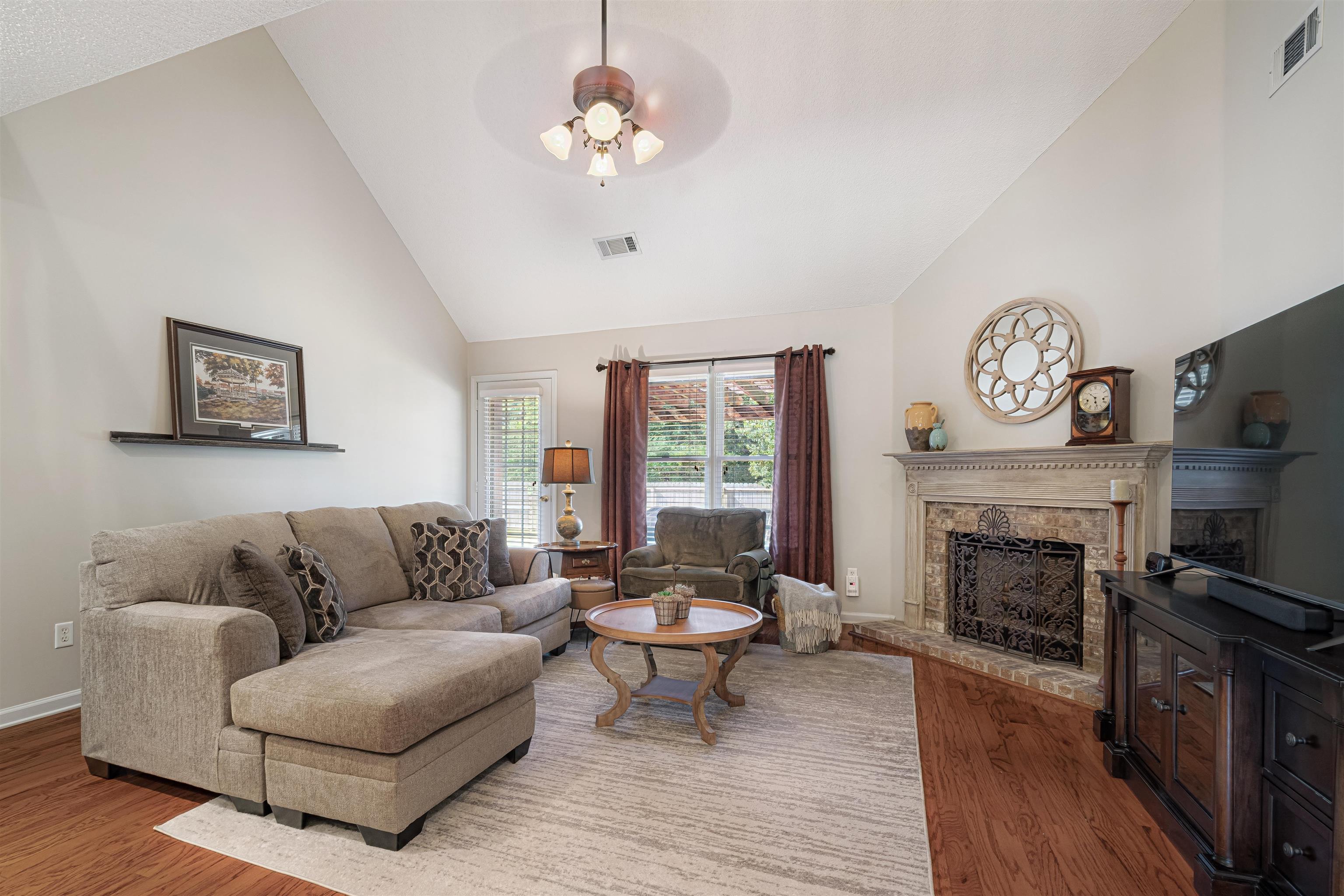 1337 Hunters Mill Trail Collierville, TN 38017 - Photo 6 of 25 a living room with furniture a fireplace and a flat screen tv