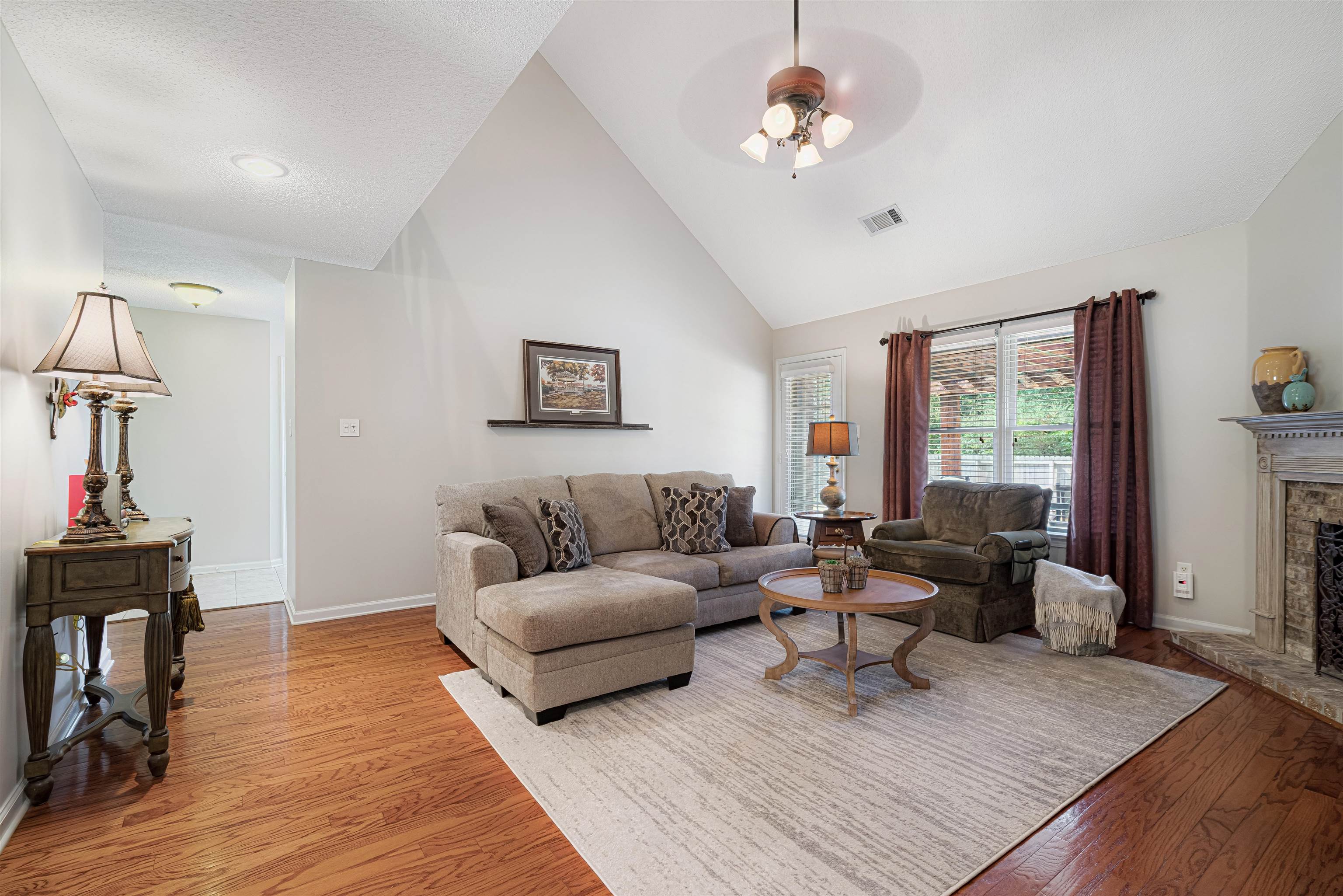 1337 Hunters Mill Trail Collierville, TN 38017 - Photo 8 of 25 a living room with furniture a chandelier and a window
