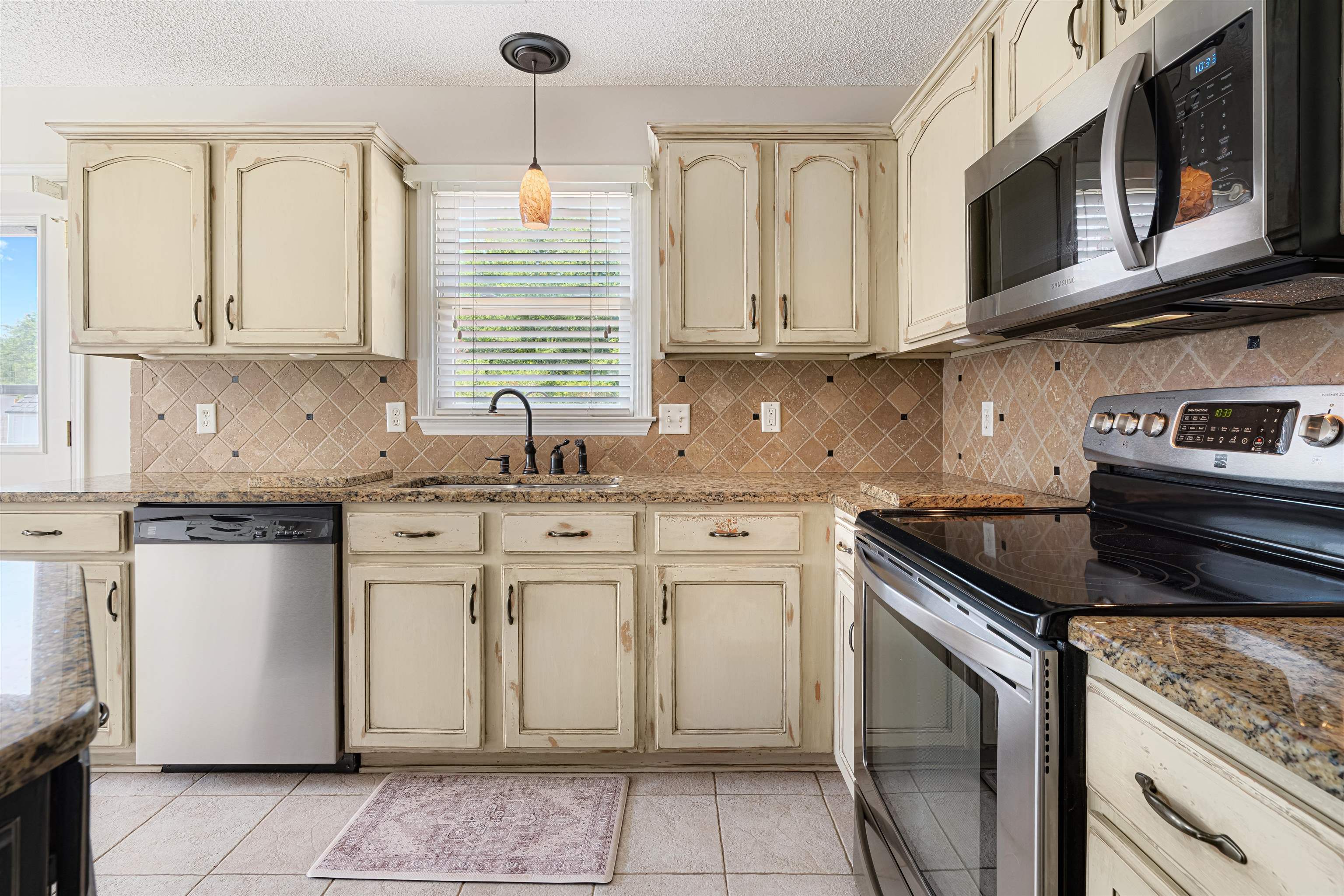 1337 Hunters Mill Trail Collierville, TN 38017 - Photo 10 of 25 a kitchen with stainless steel appliances granite countertop a sink stove and cabinets