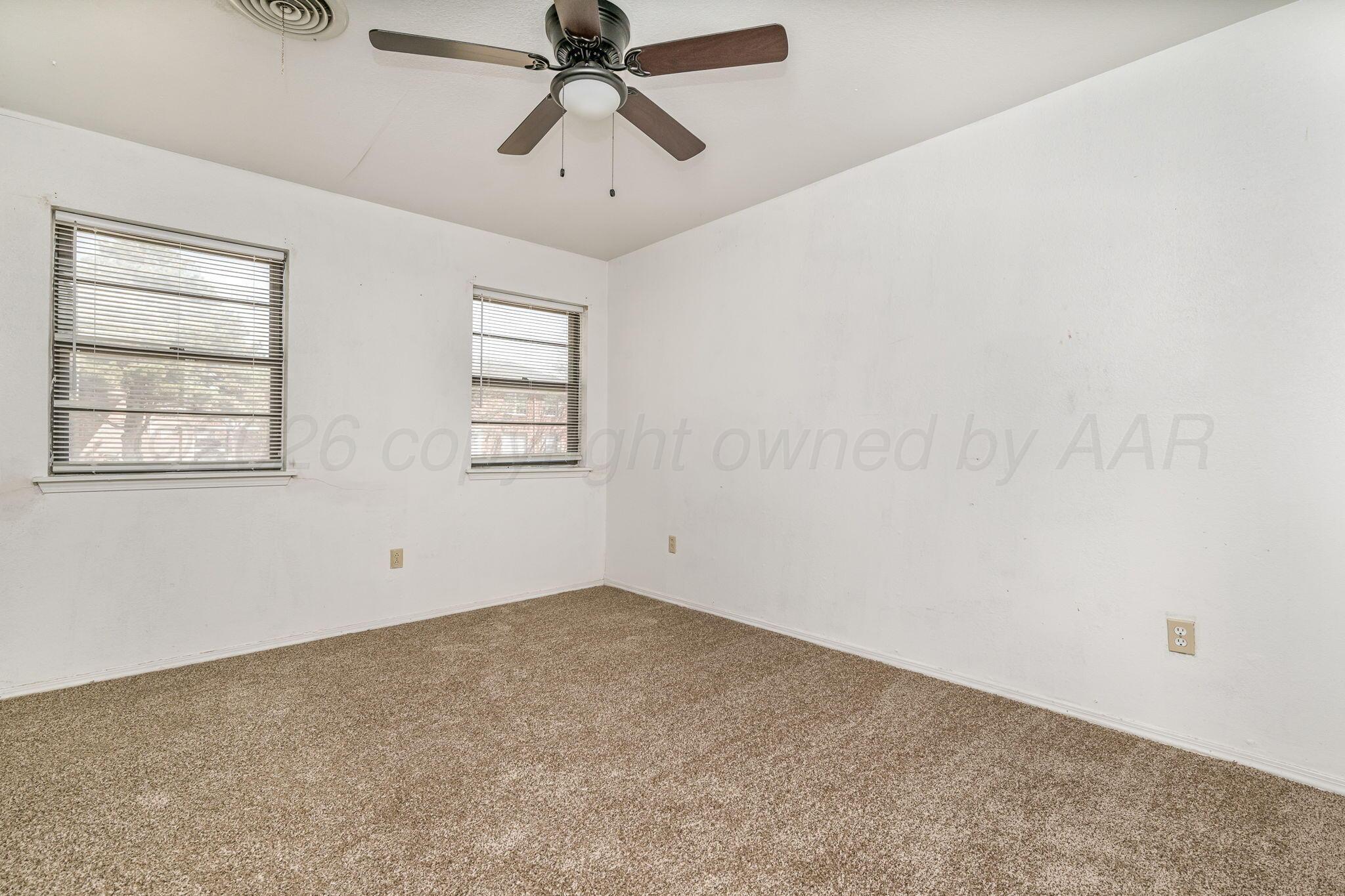 3103 Southwest 27th Avenue Amarillo, TX 79109 - Photo 15 of 21 an empty room with windows and fan